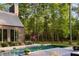 Backyard featuring a stunning in-ground pool, a wooden patio, and lush landscaping at 2885 Plow Ground Rd, Johns Island, SC 29455