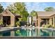 Backyard featuring a stunning in-ground pool, a wooden patio, and lush landscaping at 2885 Plow Ground Rd, Johns Island, SC 29455