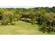 Picturesque aerial view of a pond surrounded by lush greenery and mature trees, showcasing the natural beauty at 2885 Plow Ground Rd, Johns Island, SC 29455