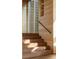 Wooden staircase with natural light streaming in, showcasing the detail of the home at 2885 Plow Ground Rd, Johns Island, SC 29455