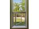 A window view looks out into a lush and inviting forested area with walking path at 2885 Plow Ground Rd, Johns Island, SC 29455