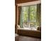 Window seat with plush cushions offers great views of the surrounding nature, complemented by custom wood detail at 2885 Plow Ground Rd, Johns Island, SC 29455