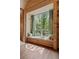 Charming window seat featuring a view of a lush forest, custom wood detail, and beautiful green and white curtains at 2885 Plow Ground Rd, Johns Island, SC 29455