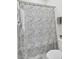 A bathroom featuring a toilet and a bathtub with a patterned shower curtain at 2928 Tranquility Rd, Mount Pleasant, SC 29466