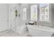Serene bathroom with a freestanding tub, frameless shower, and natural light, blending luxury with relaxation at 2928 Tranquility Rd, Mount Pleasant, SC 29466