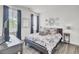 Charming bedroom features a bed with decorative pillows, dark curtains, and modern decor at 2928 Tranquility Rd, Mount Pleasant, SC 29466