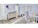Bright Bedroom with a changing table, wall decor, and a crib with an area rug at 2928 Tranquility Rd, Mount Pleasant, SC 29466