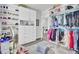 Spacious walk-in closet with shelving for shoes, hanging racks for clothes and a center cabinet at 2928 Tranquility Rd, Mount Pleasant, SC 29466