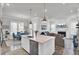 Open-concept kitchen and living area with an island, stainless steel appliances, and cozy fireplace at 2928 Tranquility Rd, Mount Pleasant, SC 29466