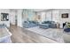 Cozy living room with stylish decor, plush blue sofas, accent wall, and hardwood floors at 2928 Tranquility Rd, Mount Pleasant, SC 29466