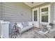 Relaxing porch with comfortable seating, decorative pillows, and outdoor decor at 2928 Tranquility Rd, Mount Pleasant, SC 29466