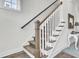 Staircase with carpeted steps, white railings, and wood accents, leading to an upper level with natural lighting at 2928 Tranquility Rd, Mount Pleasant, SC 29466
