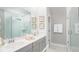 Modern bathroom with double vanity, a glass-enclosed shower, clean lines, and elegant finishes for a spa-like experience at 299 Citrus Dr, Summerville, SC 29486