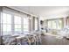 Open-concept living and dining area with hardwood floors, large windows, modern lighting, and comfortable seating at 299 Citrus Dr, Summerville, SC 29486
