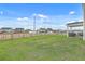 Fenced backyard features a covered patio perfect for outdoor entertaining, surrounded by a lush lawn and neighborhing homes at 302 Fox Gap Rd, Summerville, SC 29486