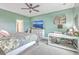 Serene bedroom with a ceiling fan, dresser, and ample natural light, creating a calming and comfortable retreat at 302 Fox Gap Rd, Summerville, SC 29486