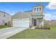 Two-story home with a white garage door, a welcoming porch, and a well-kept lawn at 302 Fox Gap Rd, Summerville, SC 29486