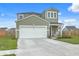 Well maintained home with a clean driveway, green siding, white garage door and front porch at 302 Fox Gap Rd, Summerville, SC 29486