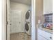 Functional laundry room featuring a stacked washer and dryer unit with convenient storage and countertop space at 302 Fox Gap Rd, Summerville, SC 29486