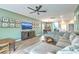 Inviting living room featuring a ceiling fan, neutral tones, and an open layout with seamless connection to dining and kitchen at 302 Fox Gap Rd, Summerville, SC 29486