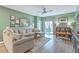 Cozy living room featuring a comfortable sectional sofa, ceiling fan, and sliding door access to the outdoor space at 302 Fox Gap Rd, Summerville, SC 29486