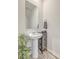 Bright powder room featuring a pedestal sink, modern fixtures, stylish mirror, and decorative accents at 302 Fox Gap Rd, Summerville, SC 29486