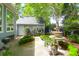 Backyard featuring a fountain, green shrubbery, and a detached garage, perfect for outdoor entertaining at 3030 Baltimore St, Charleston, SC 29492