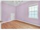 Light-filled bedroom with hardwood floors, a window, a closet, and a decorative chandelier at 3030 Baltimore St, Charleston, SC 29492