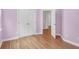 Cozy bedroom featuring hardwood floors, a double door closet, and calming purple walls at 3030 Baltimore St, Charleston, SC 29492