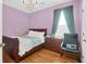 This bedroom is adorned with hardwood floors, a window, and a stylish chandelier to make the room cozy at 3030 Baltimore St, Charleston, SC 29492