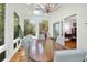 Bright dining room features hardwood floors, large windows and modern chandelier at 3030 Baltimore St, Charleston, SC 29492