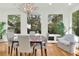 Dining Room with bright natural light, hardwood floors and modern chandelier at 3030 Baltimore St, Charleston, SC 29492