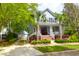 Charming two-story home with a welcoming front porch, palm trees, and manicured landscaping at 3030 Baltimore St, Charleston, SC 29492
