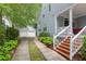 Beautiful home featuring a brick staircase, covered porch, driveway, and a detached garage at 3030 Baltimore St, Charleston, SC 29492
