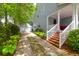 Charming home exterior features a well-maintained front yard, a brick staircase, and a two-car garage at 3030 Baltimore St, Charleston, SC 29492