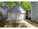 Detached two-car garage with white doors and gray siding, matching the house's aesthetic at 3030 Baltimore St, Charleston, SC 29492