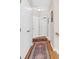 Hallway with hardwood floors, neutral walls, area rug and white doors at 3030 Baltimore St, Charleston, SC 29492