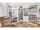Cozy study with built-in bookshelves, a comfortable recliner, and a standing lamp at 3030 Baltimore St, Charleston, SC 29492