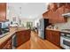 Modern kitchen with stainless steel appliances, granite countertops, and wood cabinets at 3030 Baltimore St, Charleston, SC 29492