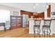 Kitchen with breakfast bar, hardwood floors, display cabinet and stainless steel refrigerator at 3030 Baltimore St, Charleston, SC 29492