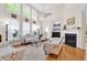 Bright and airy living room with high ceilings, large windows, and fireplace at 3030 Baltimore St, Charleston, SC 29492