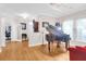 Spacious living room boasting a grand piano, hardwood floors and a chandelier at 3030 Baltimore St, Charleston, SC 29492