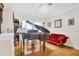 Cozy living room featuring a grand piano, a red velvet couch, and hardwood floors at 3030 Baltimore St, Charleston, SC 29492