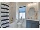 Well-lit bathroom featuring a tub with shower, modern vanity, and a stylish round mirror at 310 Ripple Park Dr, Summerville, SC 29486