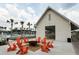 Outdoor fire pit and seating area with orange Adirondack chairs outside the clubhouse, great for entertaining at 310 Ripple Park Dr, Summerville, SC 29486