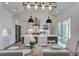 Open kitchen featuring modern light fixtures, stainless steel appliances, and a large island at 310 Ripple Park Dr, Summerville, SC 29486