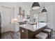 Close up of kitchen island with white marble countertop and pendant lighting at 310 Ripple Park Dr, Summerville, SC 29486