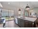 Modern kitchen island with an undermount sink and open view to the backyard patio at 310 Ripple Park Dr, Summerville, SC 29486