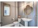 Stylish powder room with modern fixtures, elegant mirror, and designer lighting at 310 Ripple Park Dr, Summerville, SC 29486