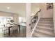 Bright living room features hardwood floors, a dining area, and stairs leading to the upper level at 325 Calm Water Way, Summerville, SC 29486